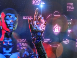 A futuristic robot hand interacting with a digital security interface, symbolizing AI cybersecurity risks such as deepfakes, ransomware, and data theft.